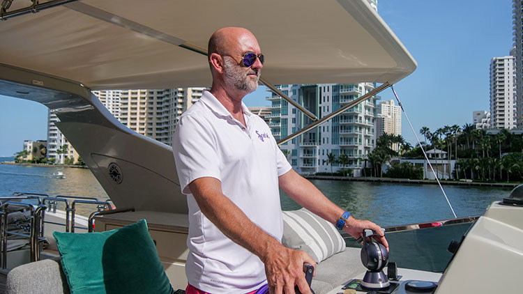 A man standing on a boat in the water